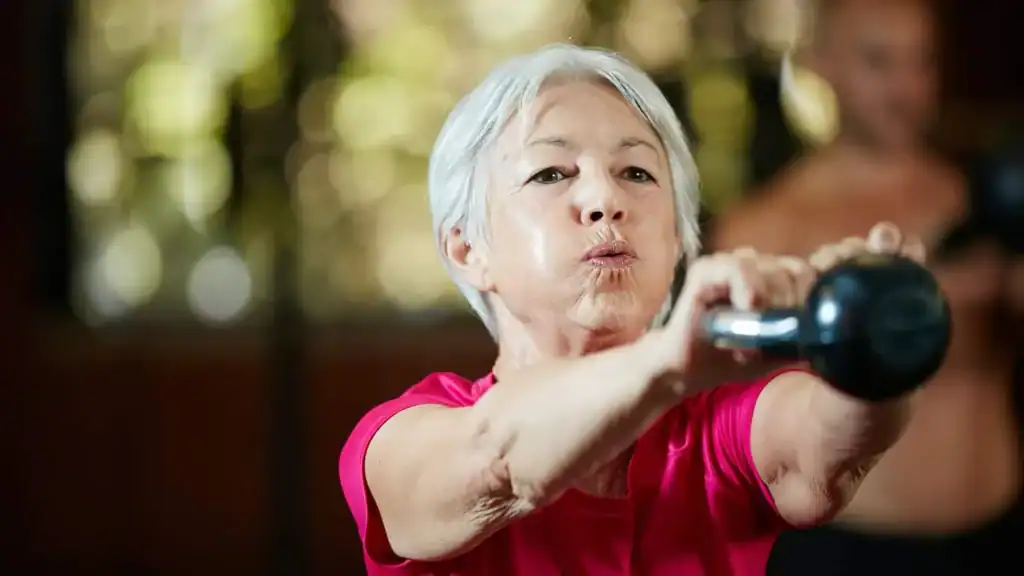 Older woman doing weight training Westcliff-on-Sea to help her strength and longevity 