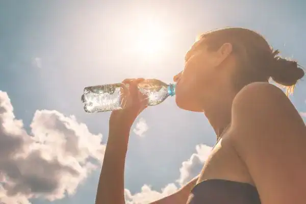 Hydration: The Secret Ingredient for a Toned Stomach and Enhanced Fitness 3 Image of woman drinking water to hydrate Westcliff-on-Sea after run.