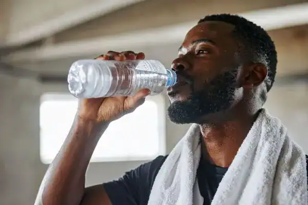 Image of man drinking water to improve hydration Westcliff-on-Sea after work out.